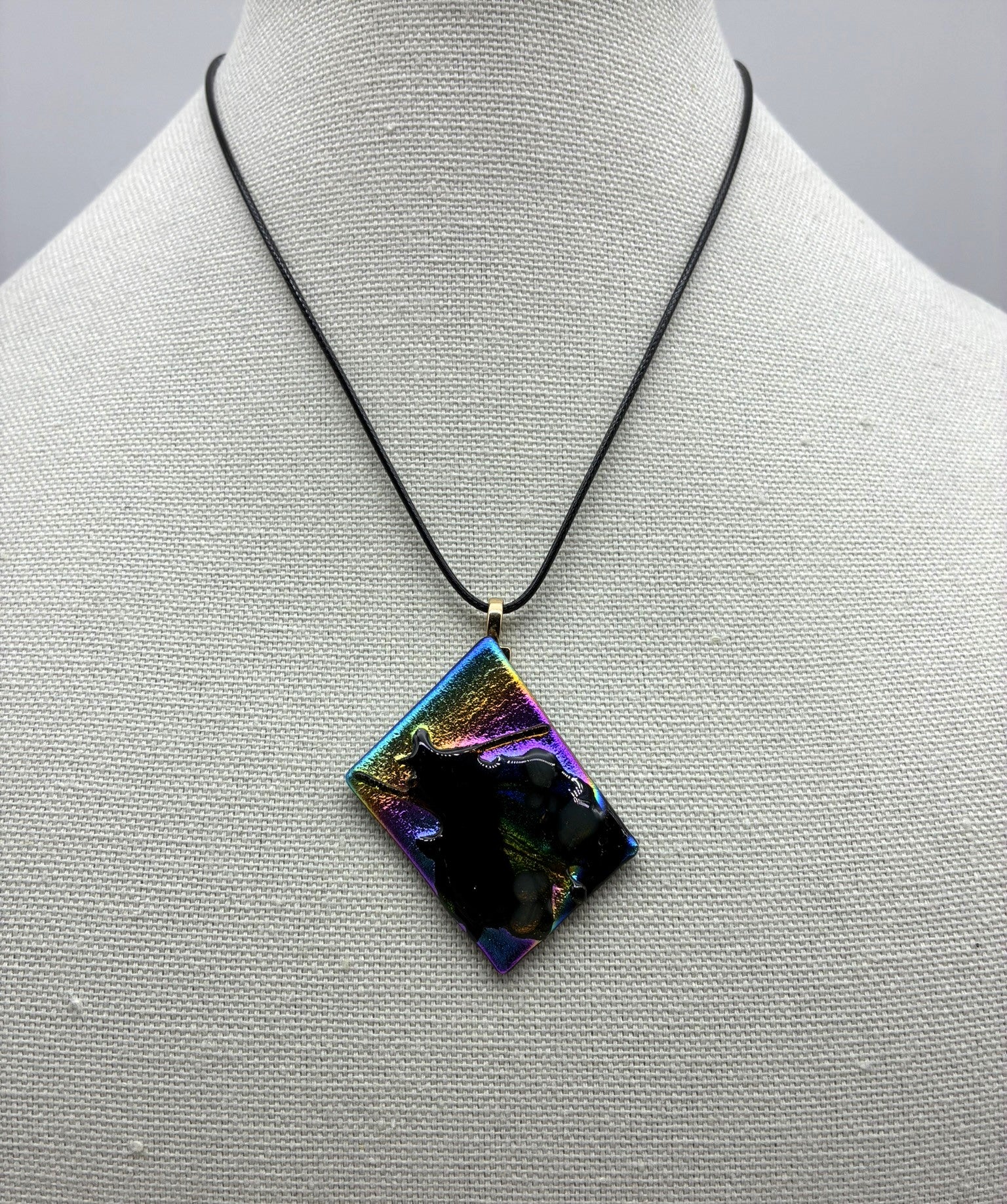 Jewelry -Offset square of black glass with dichroic and Black shiny glass - shape of witch on broom emerging.