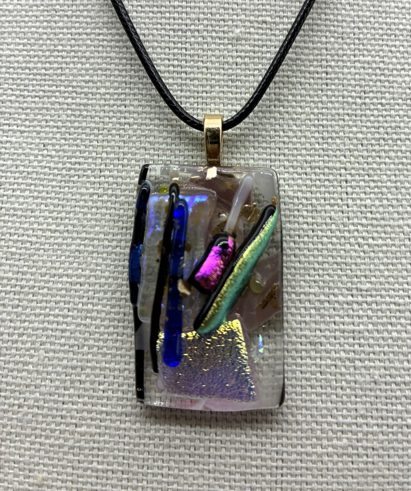 Jewelry - Small clear glass rectangle holding silver pot with a number colored sticks coming out of it.