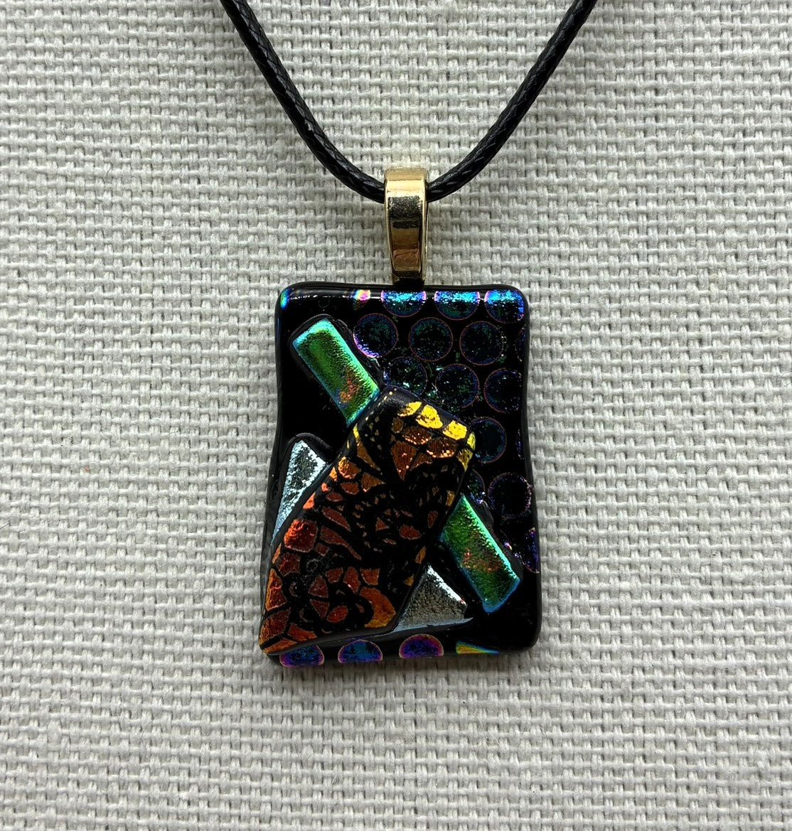 Jewelry - Small black with blue circles rectangle holding other small dichroic pieces of glass.