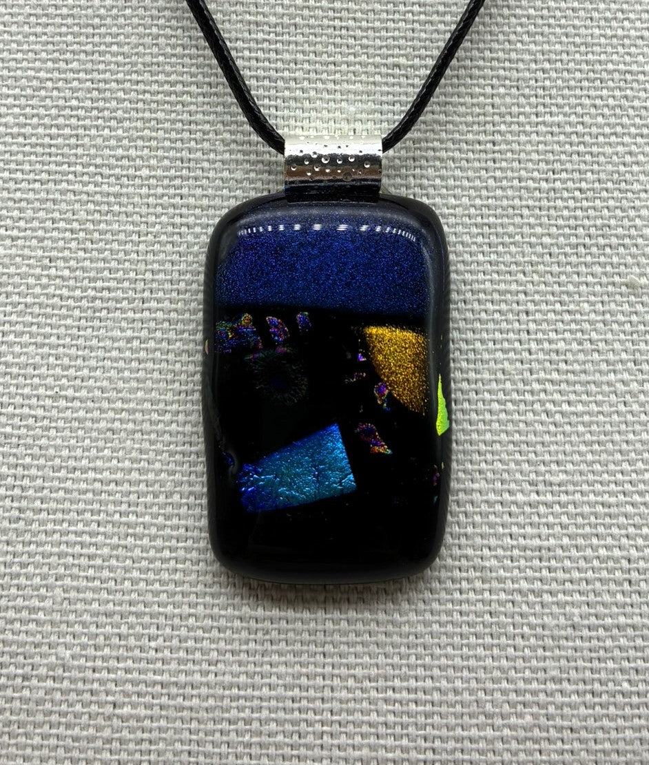 Jewelry - Small Oblong Opaque Black with Varying Color pieces of Dichroic glass embedded in Glass pendant