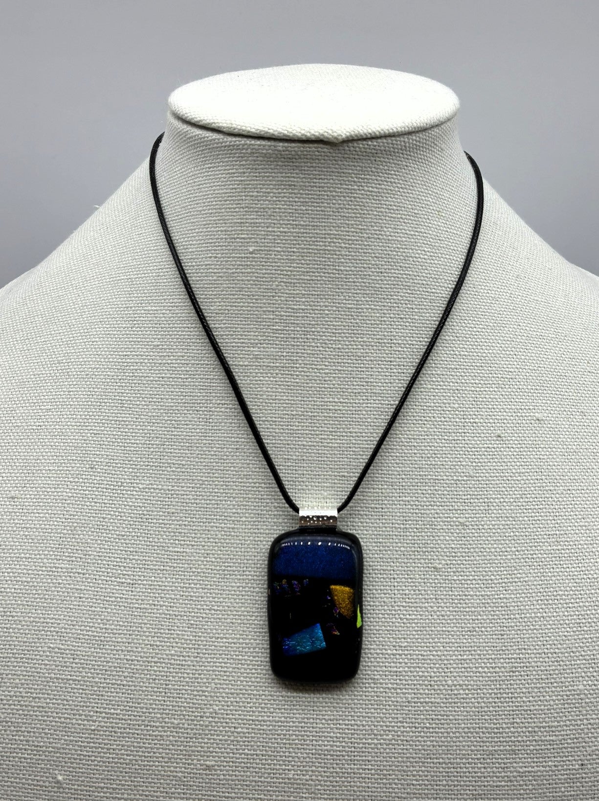 Jewelry - Small Oblong Opaque Black with Varying Color pieces of Dichroic glass embedded in Glass pendant