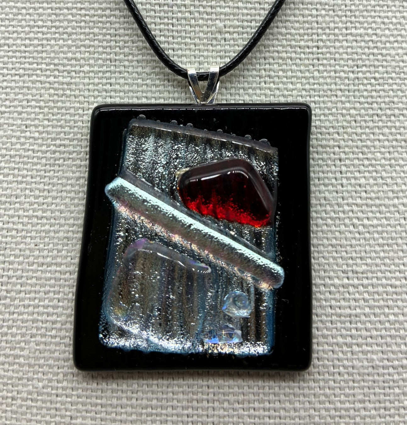 Jewelry -Rectangle Black raised glass with silver dichroic glass in middle with red triangle and sliver wand.