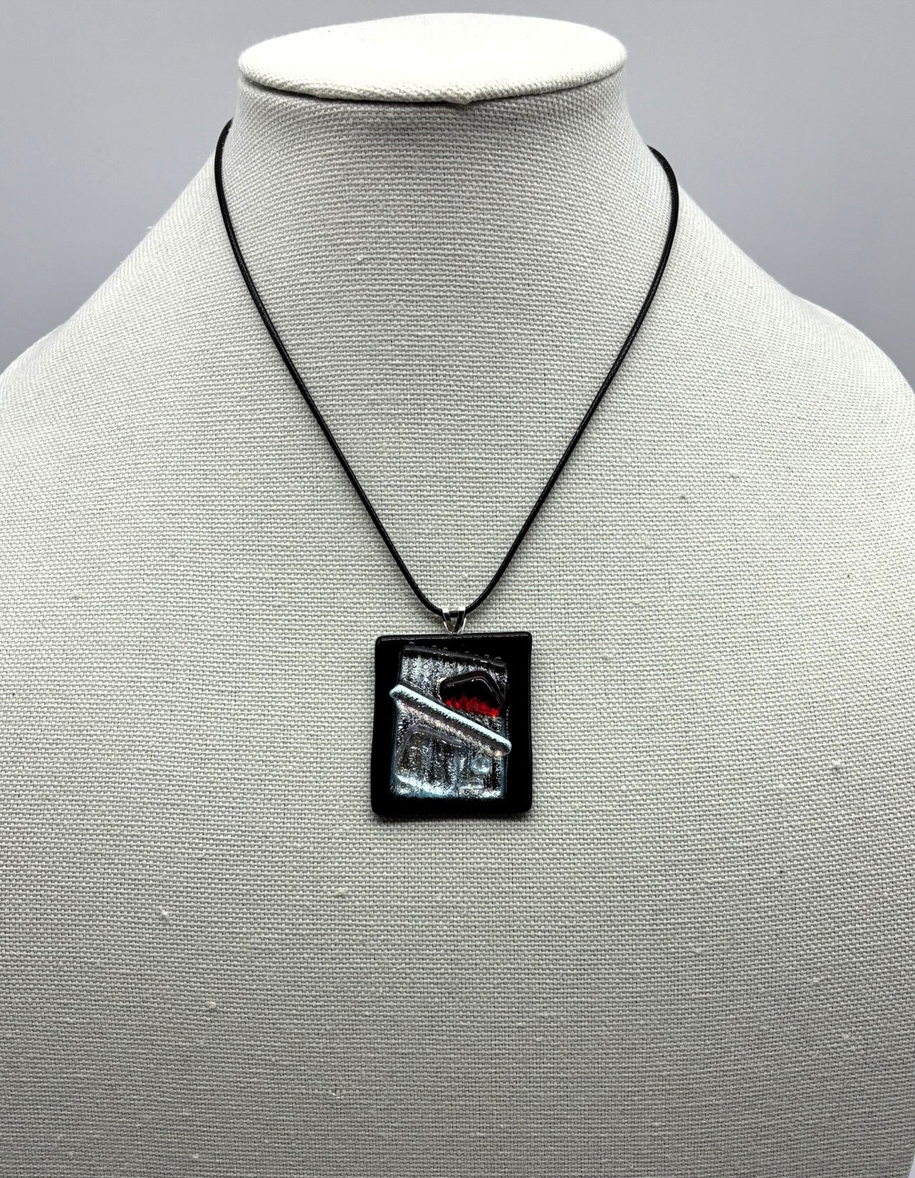 Jewelry -Rectangle Black raised glass with silver dichroic glass in middle with red triangle and sliver wand.
