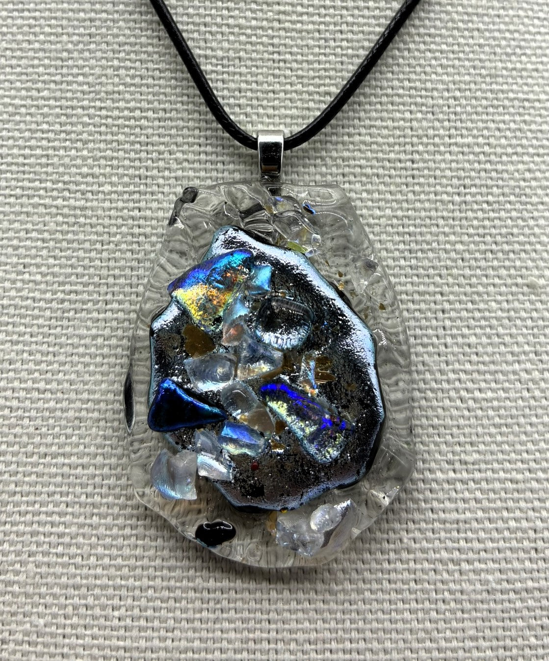 Jewelry- Oval cut piece of clear ridged glass with silver center of Dichroic glass