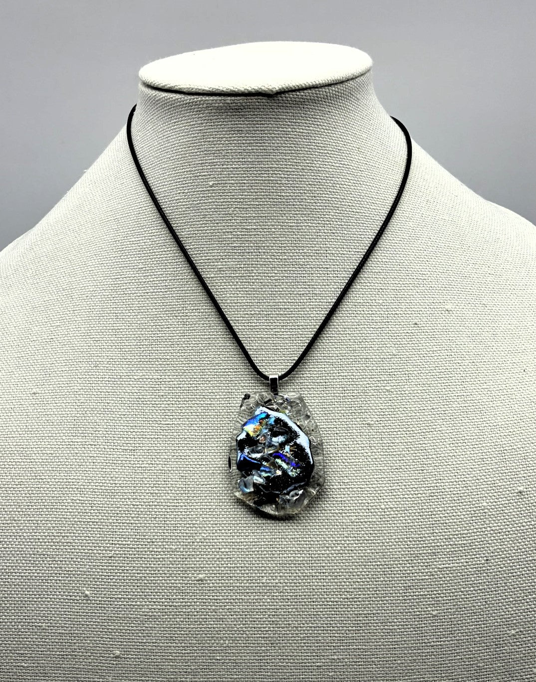 Jewelry- Oval cut piece of clear ridged glass with silver center of Dichroic glass