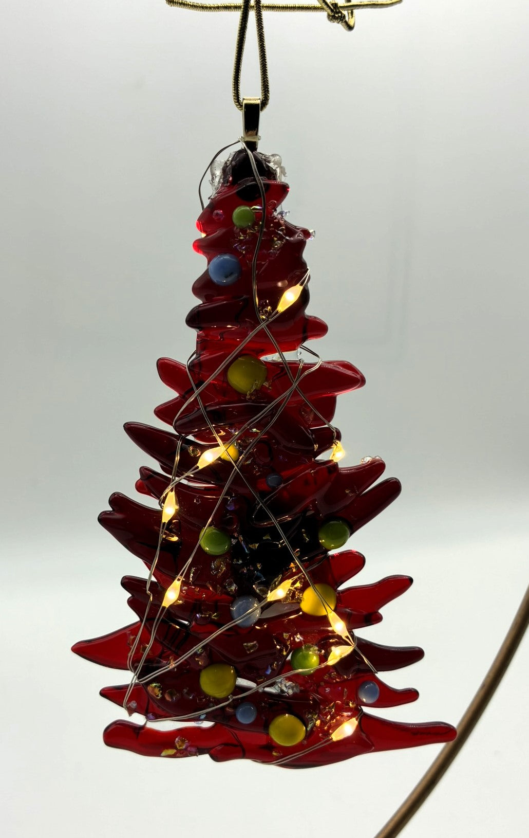Red Christmas tree with green, yellow and blue balls with lights ornament